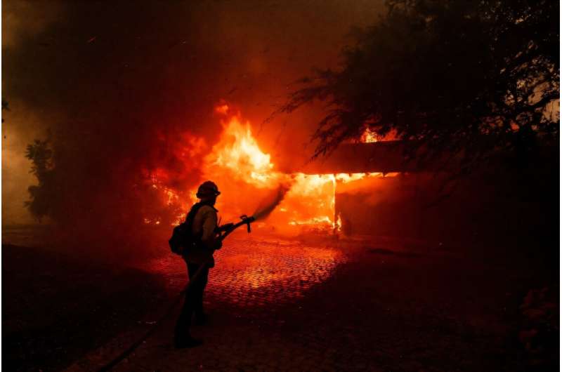 A fast-moving fire near Los Angeles has forced thousands from their homes and destroyed dozens of properties. A fast-moving fire near Los Angeles has forced thousands from their homes and destroyed dozens of properties